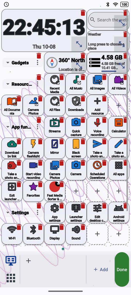 The launcher desktop in edit mode, every square drawn as a card with a remove mark, and the taskbar showing Done and a plus button