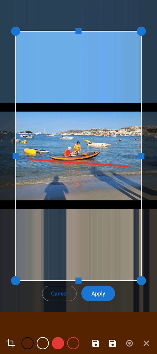 A crop frame with corner handles over a photo inside the drawing editor, with the Brush stroke already drawn kept visible underneath